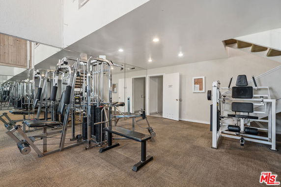 Indoor gym area with exercise equipment.