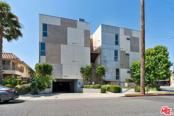 Front view of a modern multi-story building with a geometric facade.