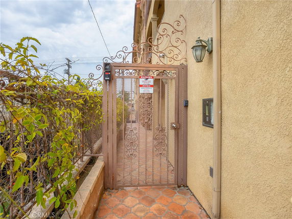 Entrance gate of a building with ornate design and security features.