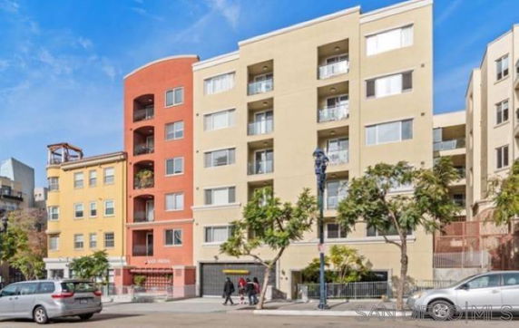 Front view of a multi-story apartment building with colorful facades.
