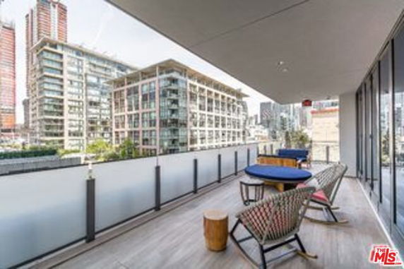 Balcony view from a building showing surrounding modern buildings.