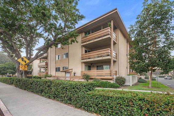 Front view of a multi-story apartment building with balconies.