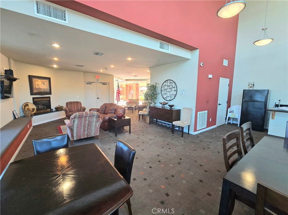 Interior view of a club house with seating and dining areas.