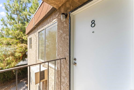 Front view of a building entry door marked with number 8.