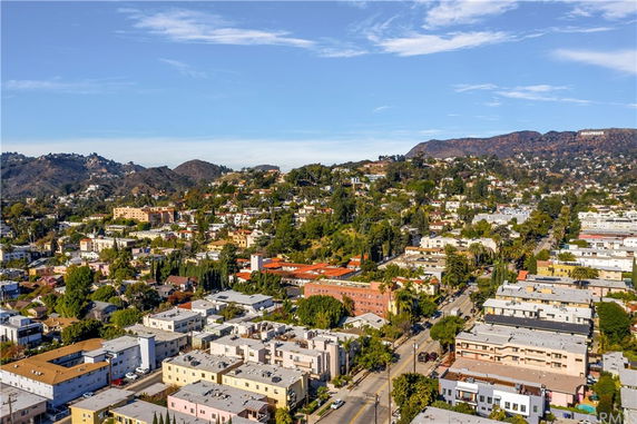 Aerial panoramic view of a residential area with hills in the background.