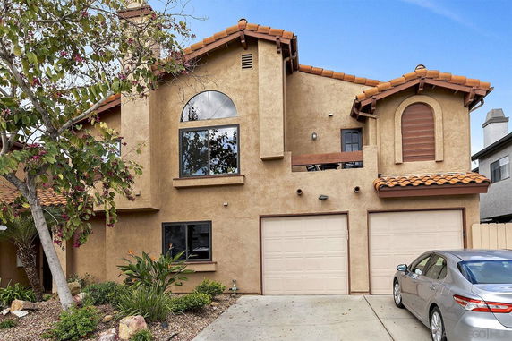 Front view of a multi-story house with a double garage.
