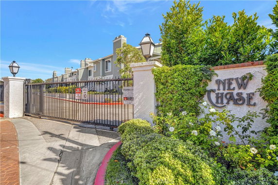 Front view of a gated residential community with multiple two-story buildings.