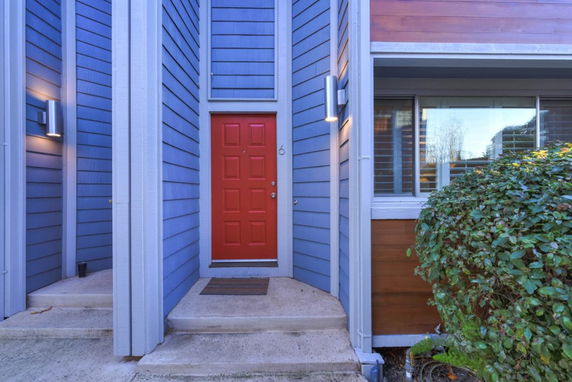 Front view of a building entrance with a red door.
