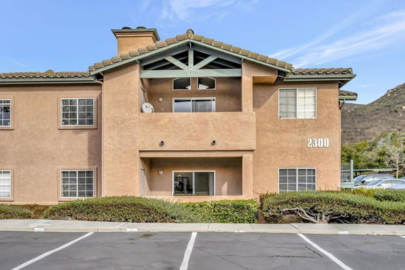 Front view of a two-story apartment building with a balcony.