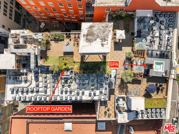 Aerial view of a rooftop with a garden and spa, surrounded by numerous air conditioning units.