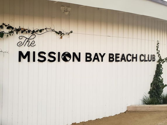 Front view of a building with signage for The Mission Bay Beach Club.