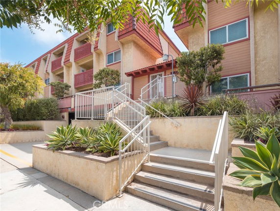 Front view of a multi-story building with stair access.