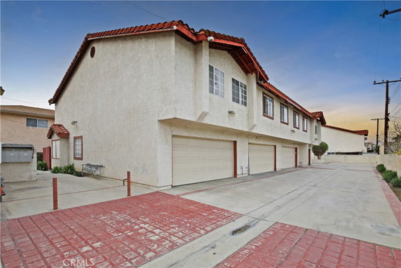 Front view of a multi-story residential building with multiple garages.
