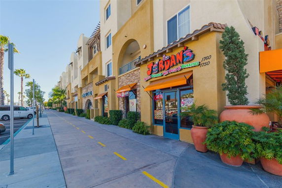 Front view of a commercial building with multiple storefronts.