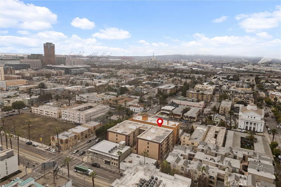 Panoramic view of a cityscape with a pointer on a building.