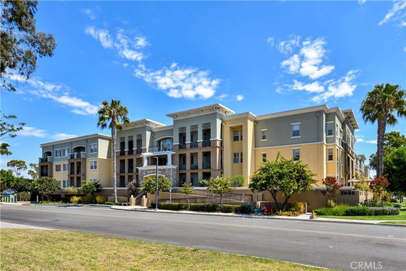 Front view of a multi-story residential building with balconies.