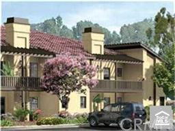Front view of a multi-story house with a tile roof and chimneys.