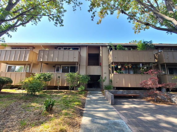Front view of a two-story residential apartment building with balconies.