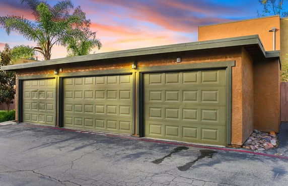 View of a building with three garage doors.