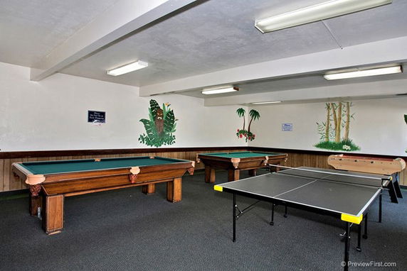 Recreation room with billiards and ping pong tables.