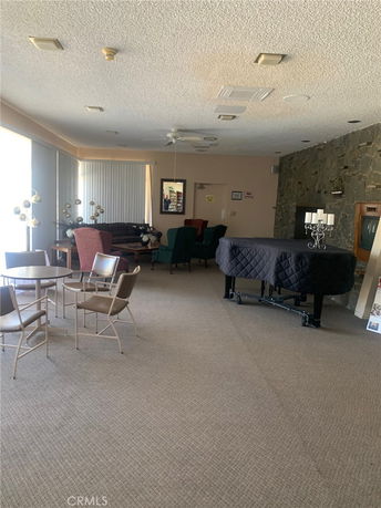 Indoor recreation area with seating and a covered piano.