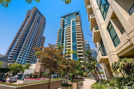 Front view of tall modern apartment buildings with multiple balconies.