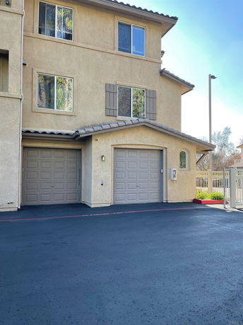 Front view of a multi-story house with a double garage.