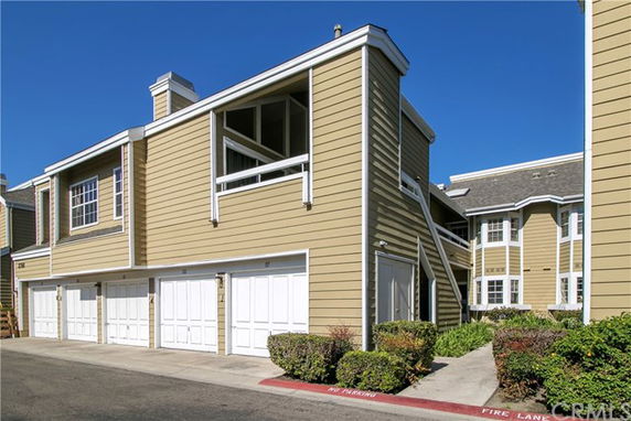 Front view of a two-story residential building with multiple garages.
