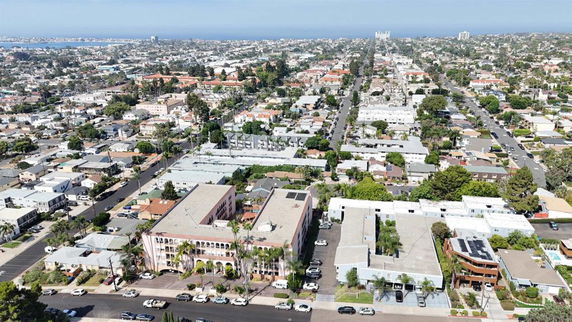 Aerial view of a residential area with a mix of low-rise buildings and houses.