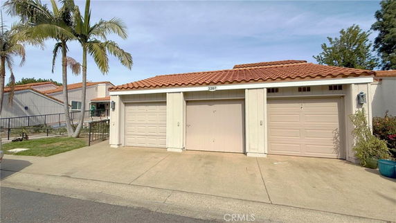 Front view of a house with a single-story design and a three-car garage.