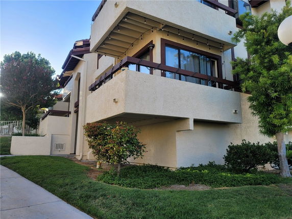 View of a multi-story building with balconies and brown accents.