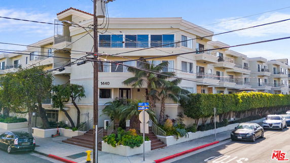 Front view of a multi-story residential building with balconies.