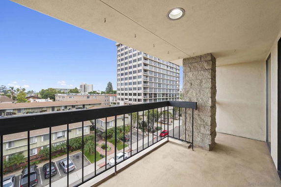 View from a building balcony overlooking nearby residential and office buildings.