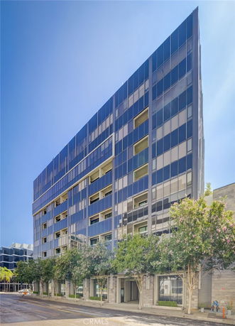 Front view of a modern multi-story building with glass facade.