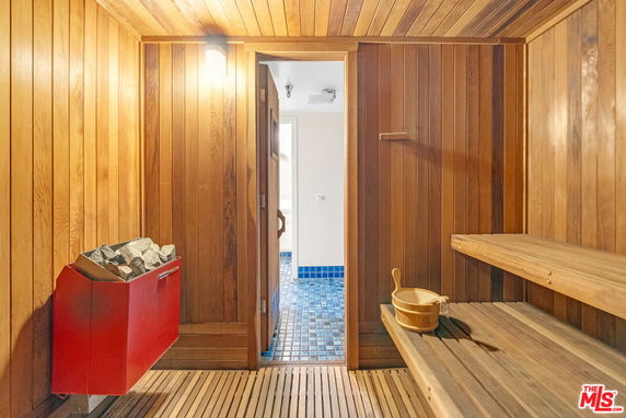 Interior view of a sauna room with wooden walls and benches.
