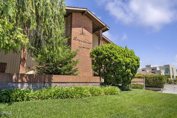 Front view of a modern multi-story building with brick facade.