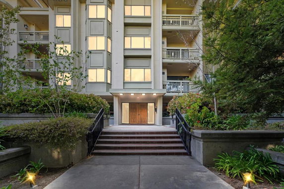 Front view of a multi-story building with a central entrance.