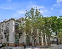 Front view of a multi-story building with large windows and balconies.
