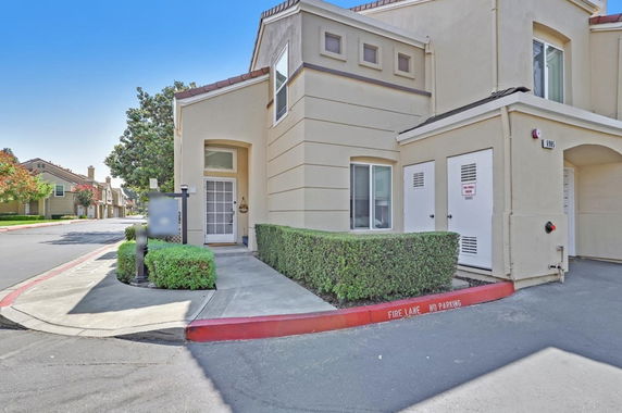 Front view of a multi-story residential building with a beige exterior.