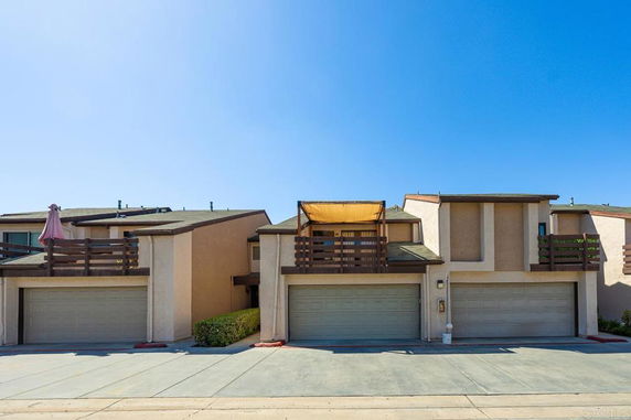 Front view of a house with a double garage and balconies.