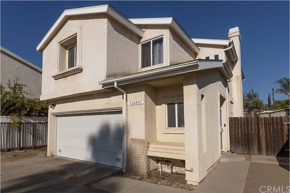 Front view of a two-story house with an attached garage.