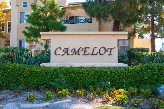 Front view of a building with the sign 'Camelot' in the foreground.