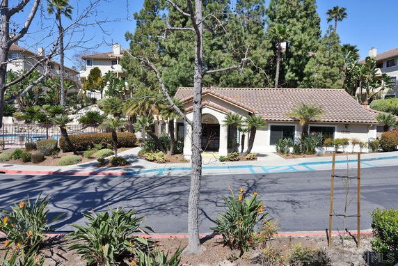 Front view of a building with a tiled roof and landscaped surroundings.