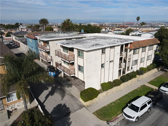 Front view of a multi-story apartment building with balconies.