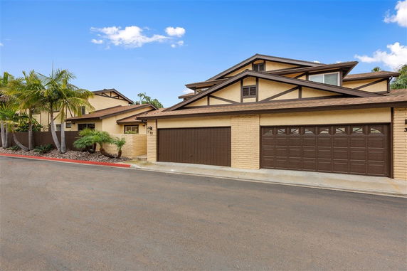 Front view of a multi-story house with a double garage.