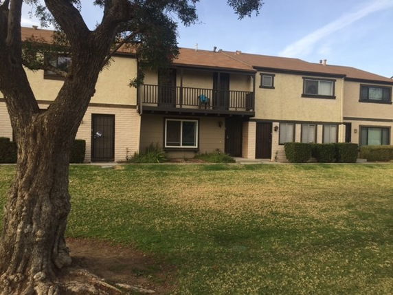 Front view of a two-story residential building with a balcony.