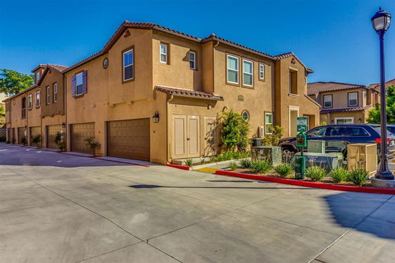 Front view of a two-story townhouse with multiple garages.