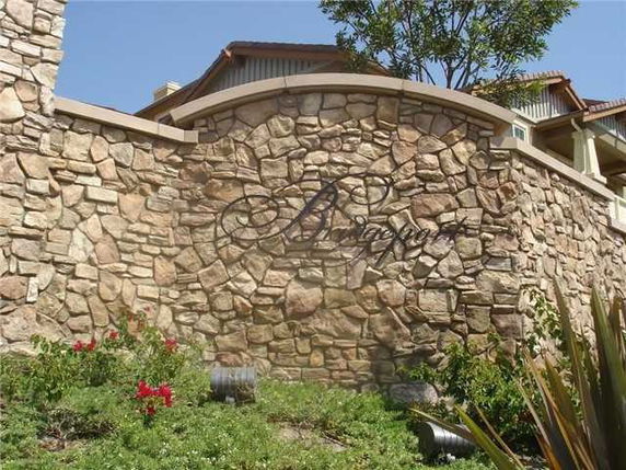 Front view of a stone wall with decorative lettering.