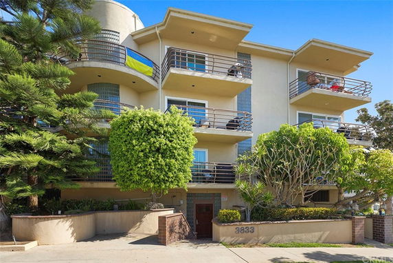 Front view of a multi-story building with balconies.
