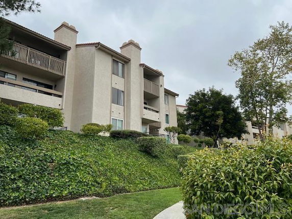 Front view of a multi-story residential building with balconies.